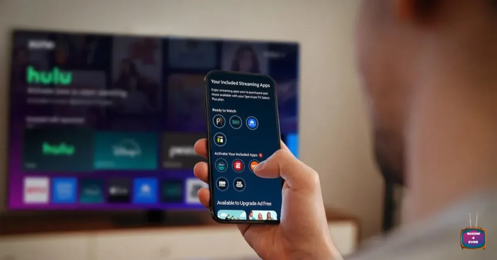 Charter Spectrum TV app streaming on smartphone with smart TV in background
